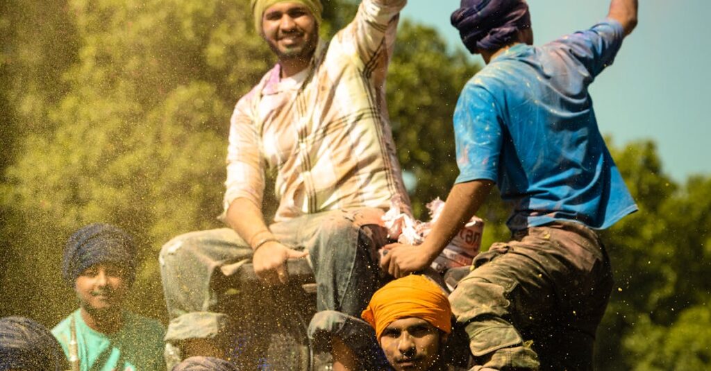 Group of cheerful farmers on a tractor celebrating in Anandpur Sahib, India.