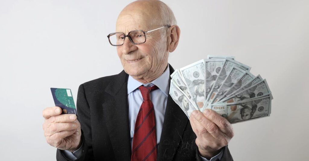 pexels-photo-3831185-3831185 Elderly man in a suit holding a credit card and US dollar bills, representing finance and wealth.