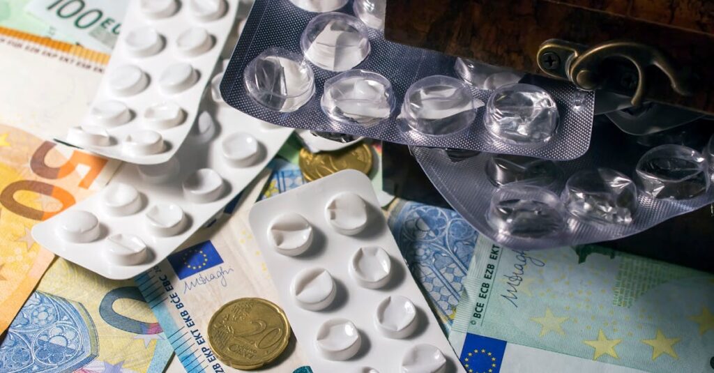 pexels-photo-4076617-4076617 Blister packs of medication placed on Euro banknotes, illustrating healthcare expenses.
