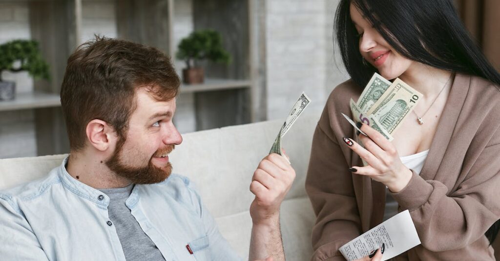 A cheerful couple managing their finances at home, holding cash and a receipt.