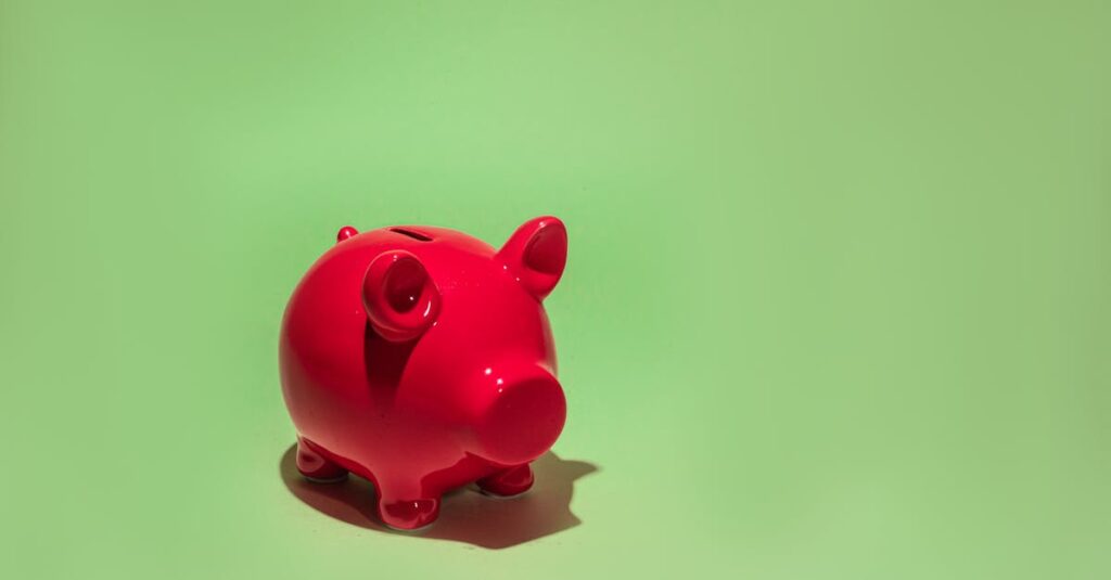 Red piggy bank on a green background symbolizing savings and financial planning.