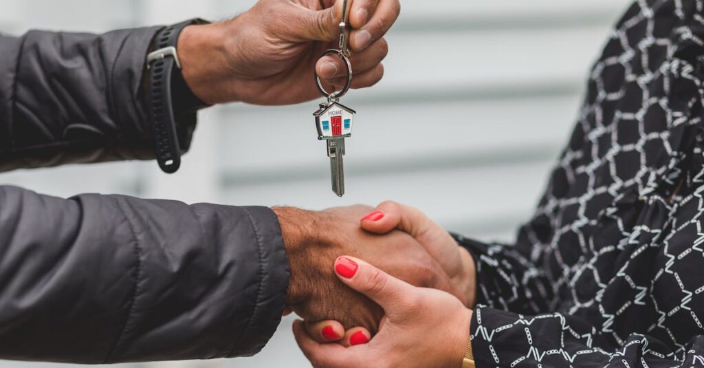 Close-up of a realtor handing over a house key to a new homeowner, symbolizing ownership and investment.